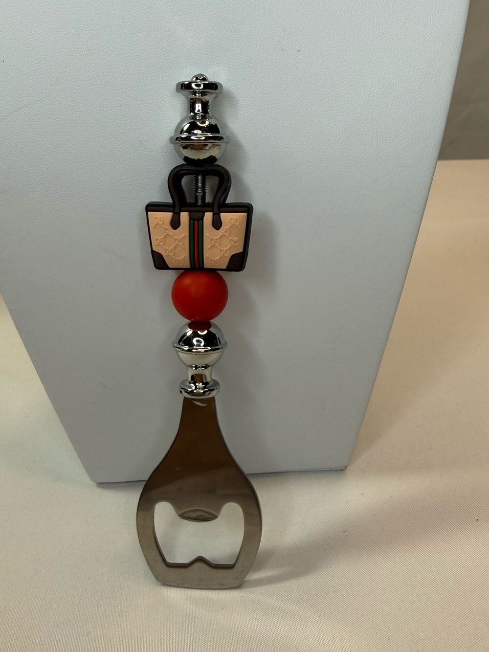 Novelty Bottle Opener with Beige Fashion Logo Purse Bag Accent and Red Bead